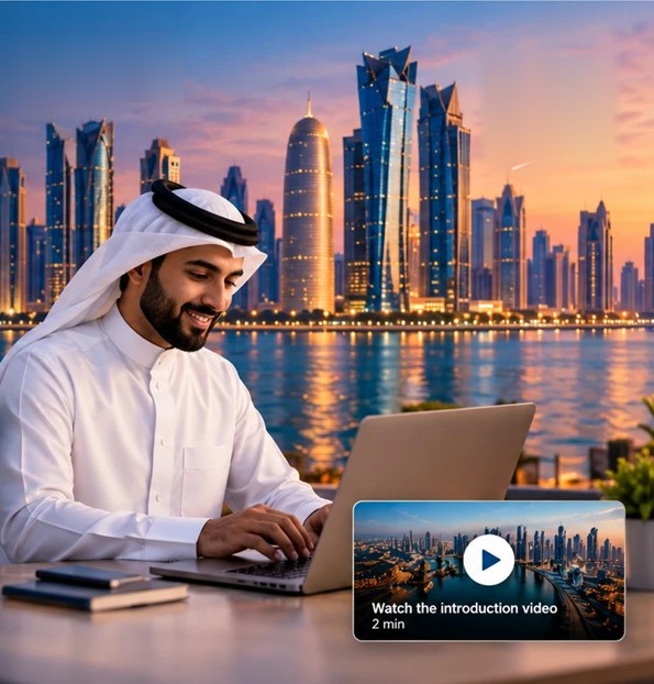 A Qatari entrepreneur working on his laptop in front of the Doha skyline at sunset